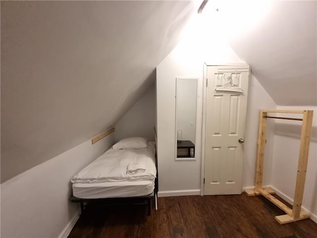 bedroom featuring dark hardwood / wood-style flooring and lofted ceiling