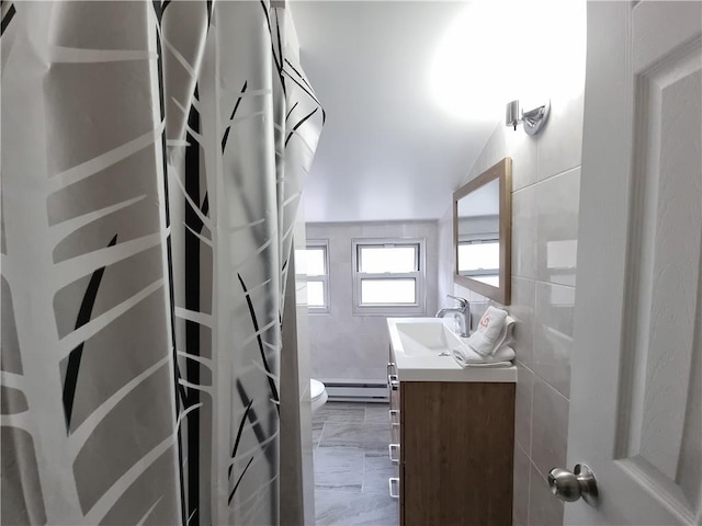 bathroom featuring toilet, a shower with shower curtain, a baseboard radiator, tile walls, and vanity