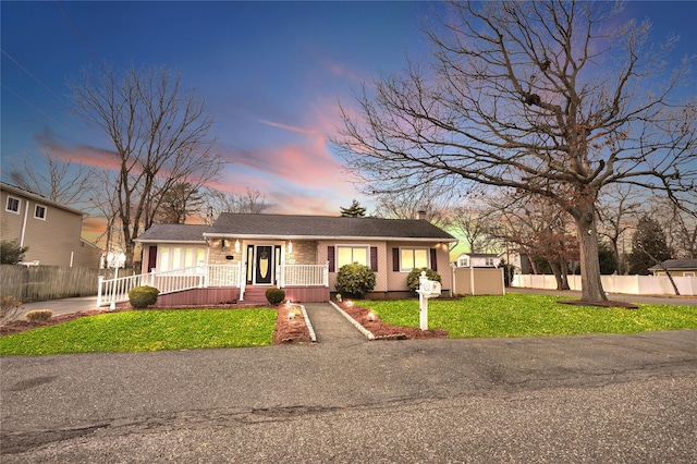 single story home featuring a lawn and a porch