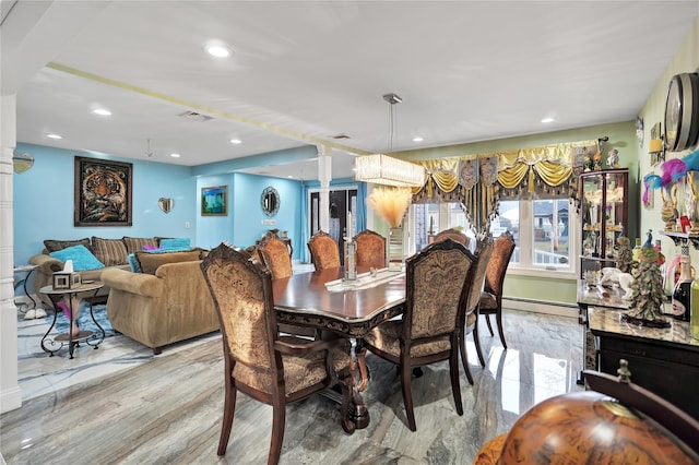 dining space featuring a baseboard heating unit