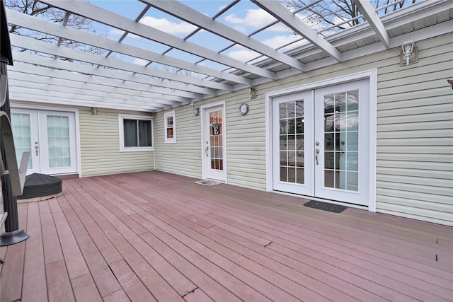 wooden terrace featuring a pergola and french doors