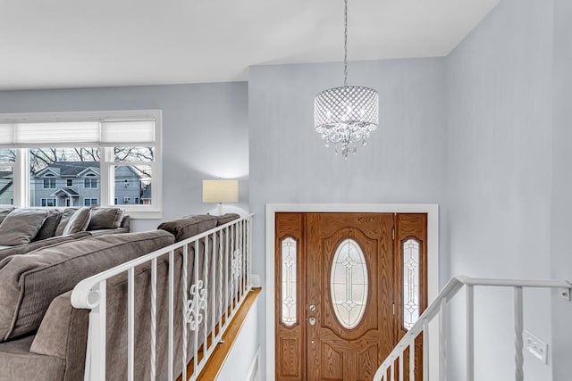 entryway with a chandelier