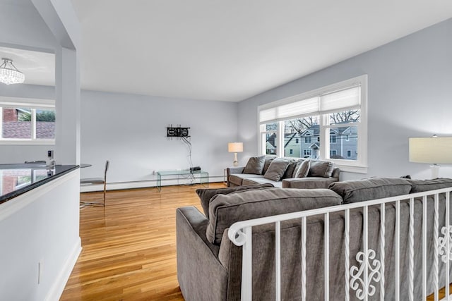 living room with baseboard heating and hardwood / wood-style flooring