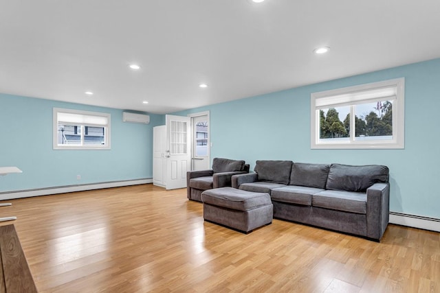 living room featuring a baseboard radiator, light wood-type flooring, and a wall mounted air conditioner