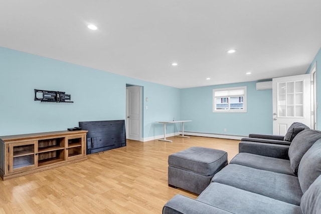 living room featuring light hardwood / wood-style floors, a wall mounted air conditioner, and a baseboard heating unit