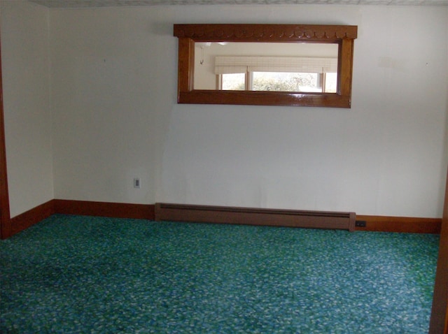 unfurnished room featuring baseboard heating and carpet floors