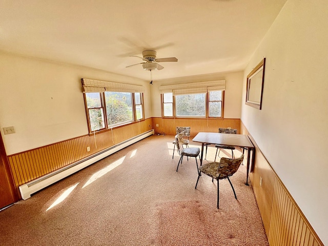 23 Riverside Dr, Roscoe, NY 12776 - carpeted dining room with baseboard heating, a ceiling fan, a wainscoted wall, and wooden walls