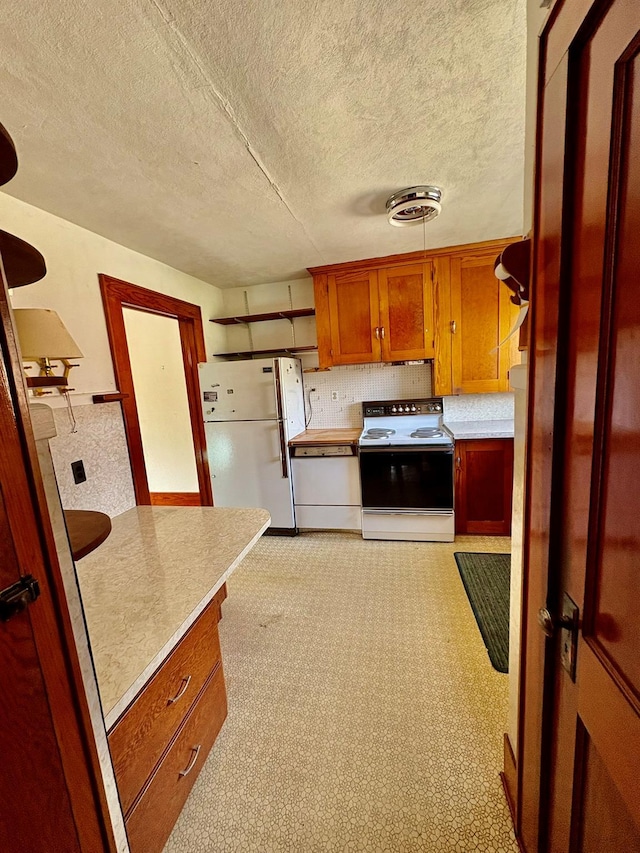 23 Riverside Dr, Roscoe, NY 12776 - kitchen featuring electric stove, brown cabinetry, light countertops, visible vents, and freestanding refrigerator