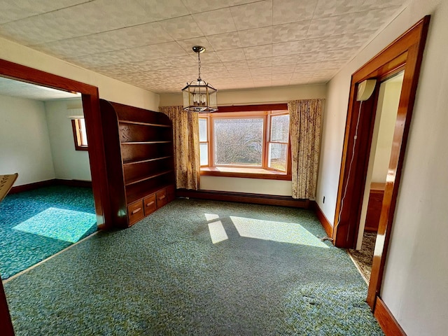 23 Riverside Dr, Roscoe, NY 12776 - unfurnished dining area featuring a baseboard radiator, baseboards, a notable chandelier, and carpet flooring
