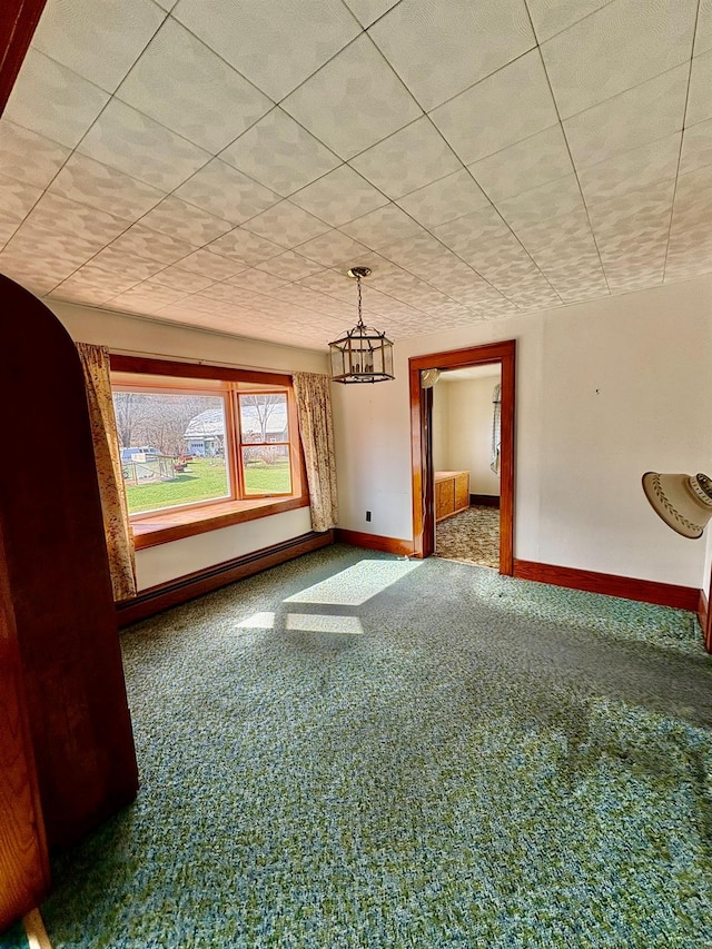 23 Riverside Dr, Roscoe, NY 12776 - carpeted empty room featuring a baseboard heating unit, baseboards, and a notable chandelier