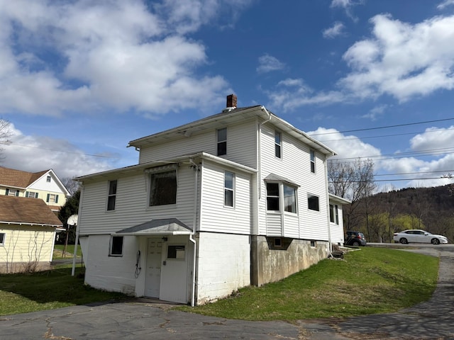 23 Riverside Dr, Roscoe, NY 12776 - back of house with a chimney and a yard