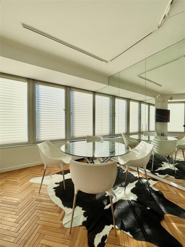 dining space featuring light parquet flooring