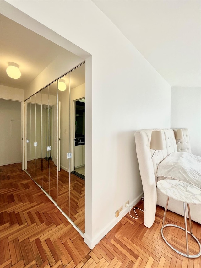 bedroom featuring a closet and parquet flooring