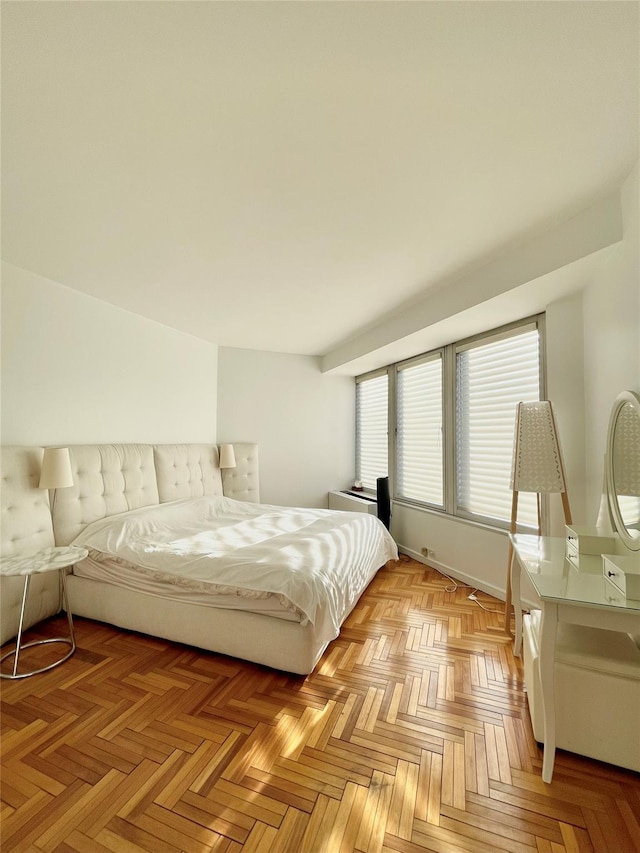 bedroom featuring light parquet flooring