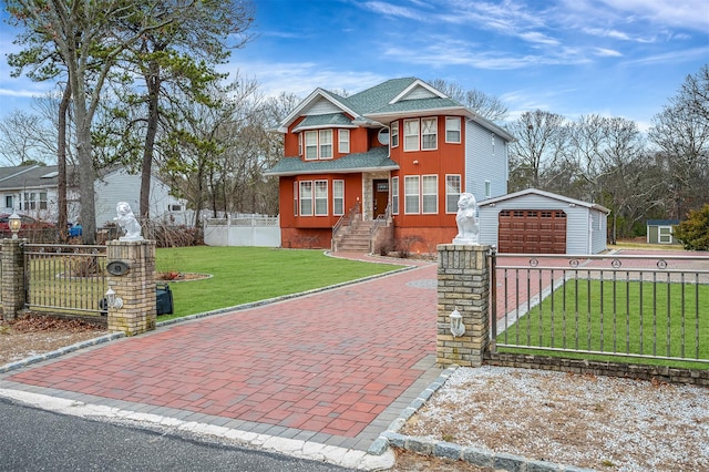 view of front of house featuring a front yard, a garage, and an outdoor structure