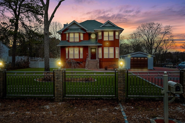 view of front of home featuring a fenced front yard, an outbuilding, a yard, and a detached garage