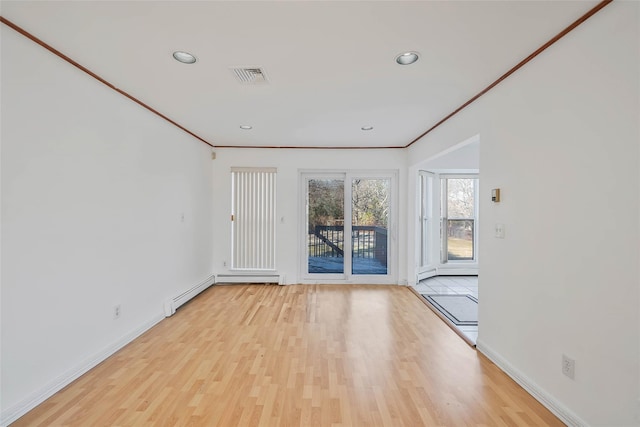 unfurnished room with ornamental molding, wood finished floors, and visible vents