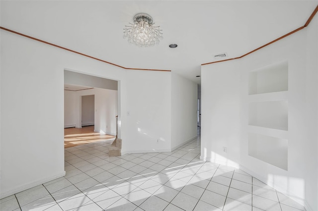 empty room with light tile patterned floors, baseboards, visible vents, and crown molding