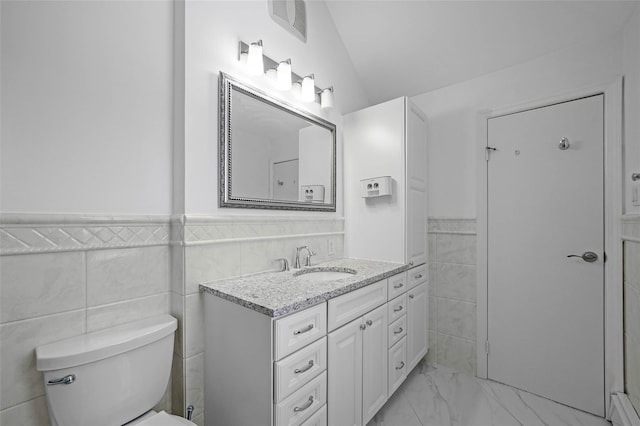 bathroom with visible vents, toilet, a wainscoted wall, marble finish floor, and vanity