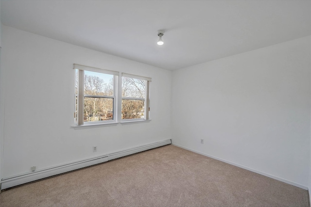 carpeted spare room featuring a baseboard radiator and baseboards