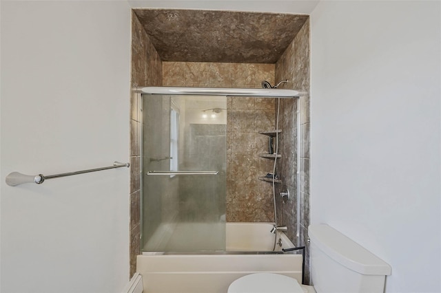 bathroom featuring toilet and bath / shower combo with glass door