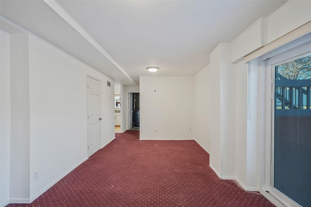 carpeted empty room with baseboards