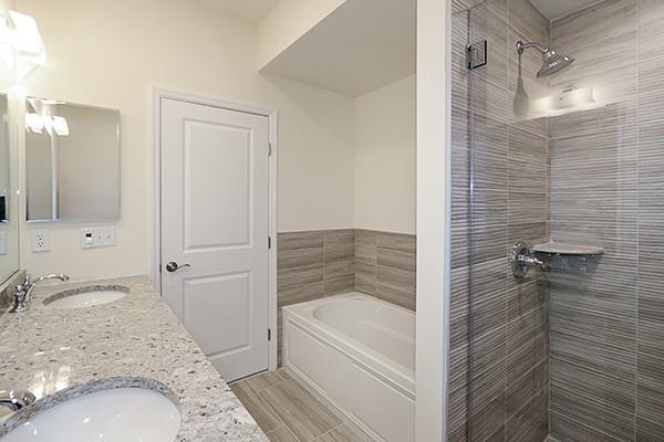 bathroom featuring plus walk in shower and vanity