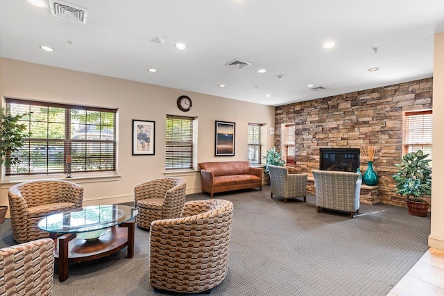 living room featuring light carpet and a fireplace