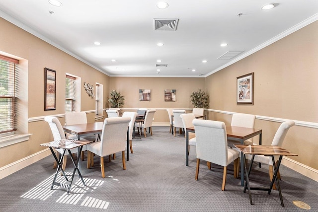 carpeted dining area with ornamental molding