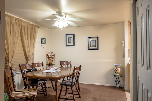 dining space featuring carpet floors and ceiling fan