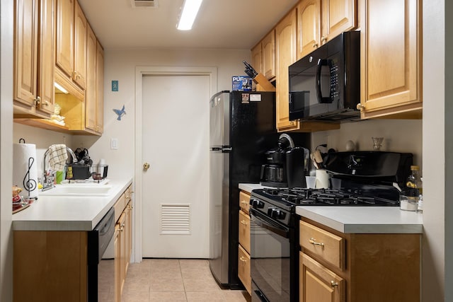 kitchen featuring light tile patterned floors, sink, and black appliances