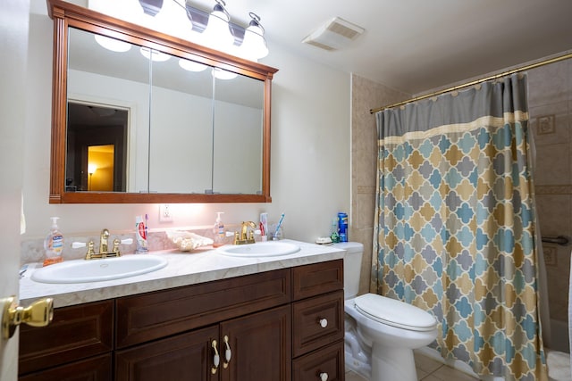 bathroom with a shower with curtain, vanity, toilet, and tile patterned flooring