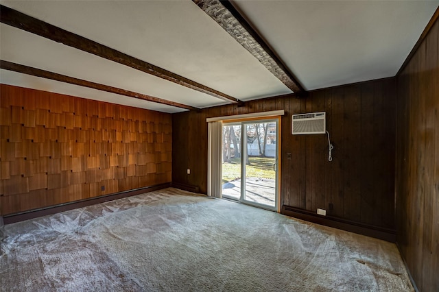 spare room featuring a wall mounted air conditioner, wooden walls, beamed ceiling, and carpet