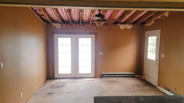 interior space with baseboard heating, a wealth of natural light, and french doors