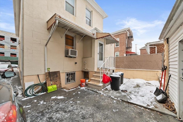 snow covered patio with cooling unit