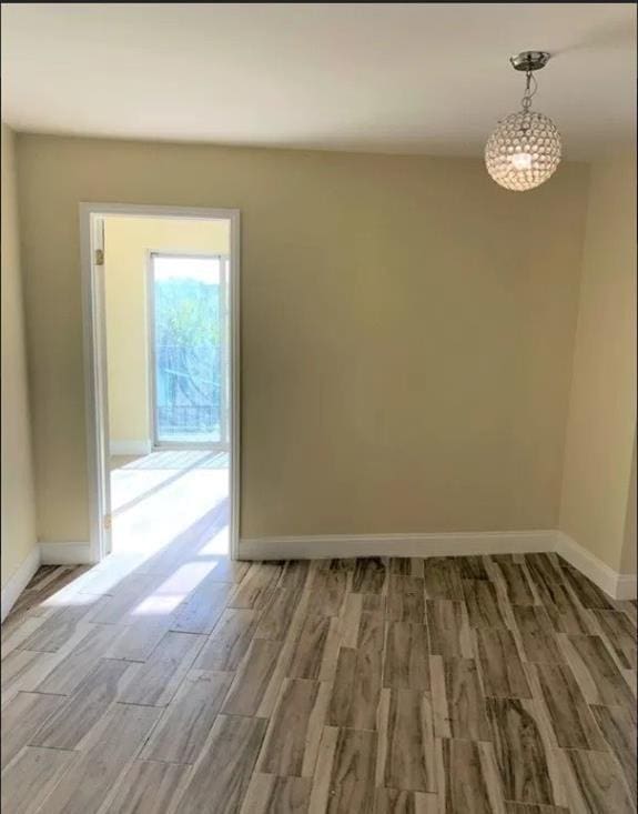 spare room with wood-type flooring