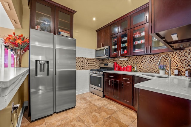 kitchen with tasteful backsplash, appliances with stainless steel finishes, and sink