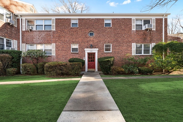 view of front of home featuring a front yard and cooling unit