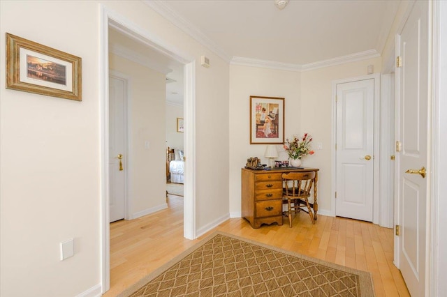 hallway featuring ornamental molding and hardwood / wood-style flooring