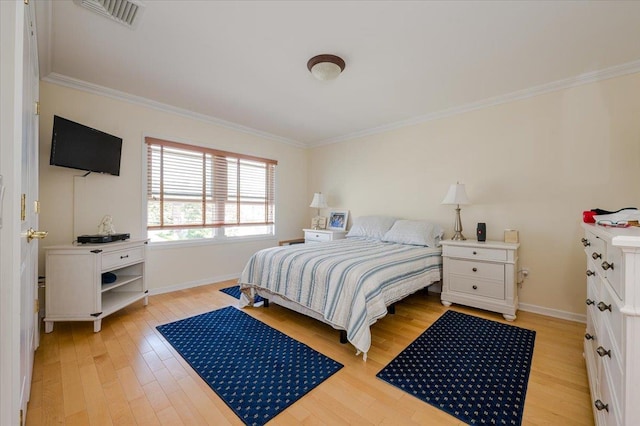 bedroom with light wood-type flooring and crown molding