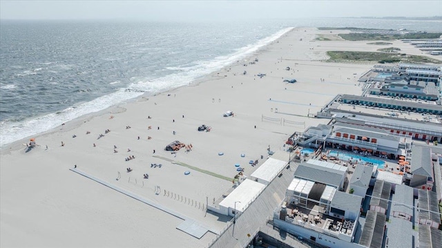 aerial view with a water view and a beach view