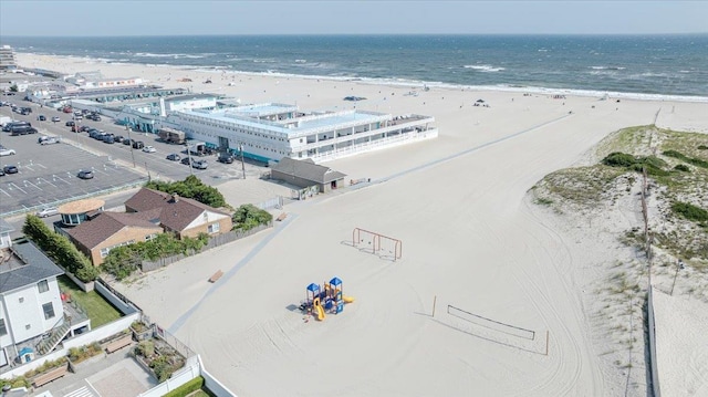 drone / aerial view featuring a water view and a beach view