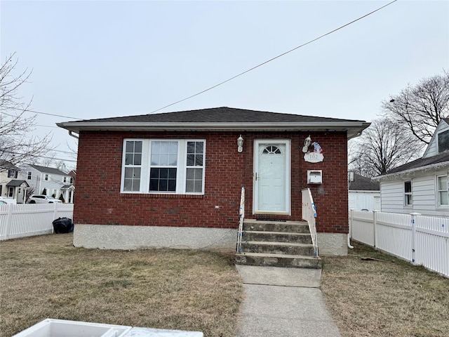 bungalow-style house featuring a front yard