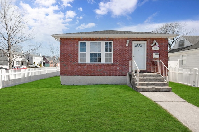 bungalow-style house with brick siding, a front yard, and fence