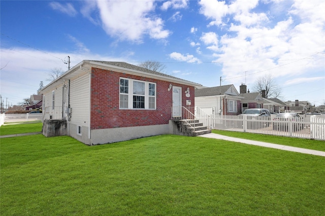 bungalow-style house with brick siding, a front lawn, and fence