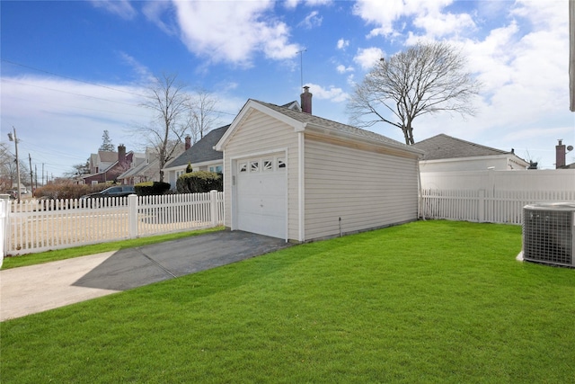 garage with cooling unit, fence, and driveway