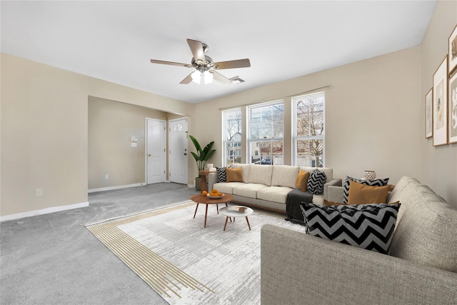 living area featuring visible vents, baseboards, ceiling fan, and carpet flooring