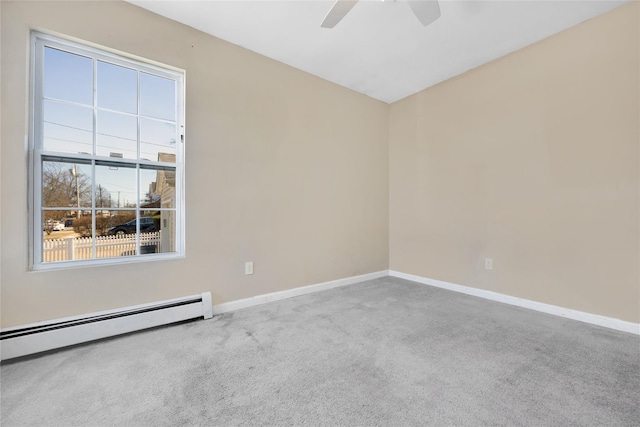 spare room featuring baseboard heating, ceiling fan, baseboards, and carpet