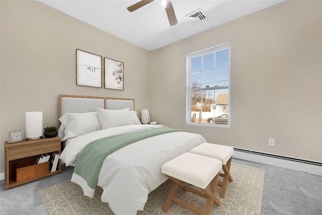 carpeted bedroom featuring ceiling fan, visible vents, and a baseboard radiator