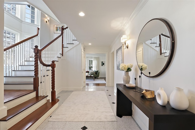 entrance foyer with a healthy amount of sunlight and crown molding